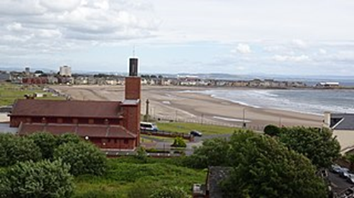 Image of a photograph, taken from the Cannon Hill in Ardrossan of the town’s Catholic church, and the sea in the background to illustrate the post