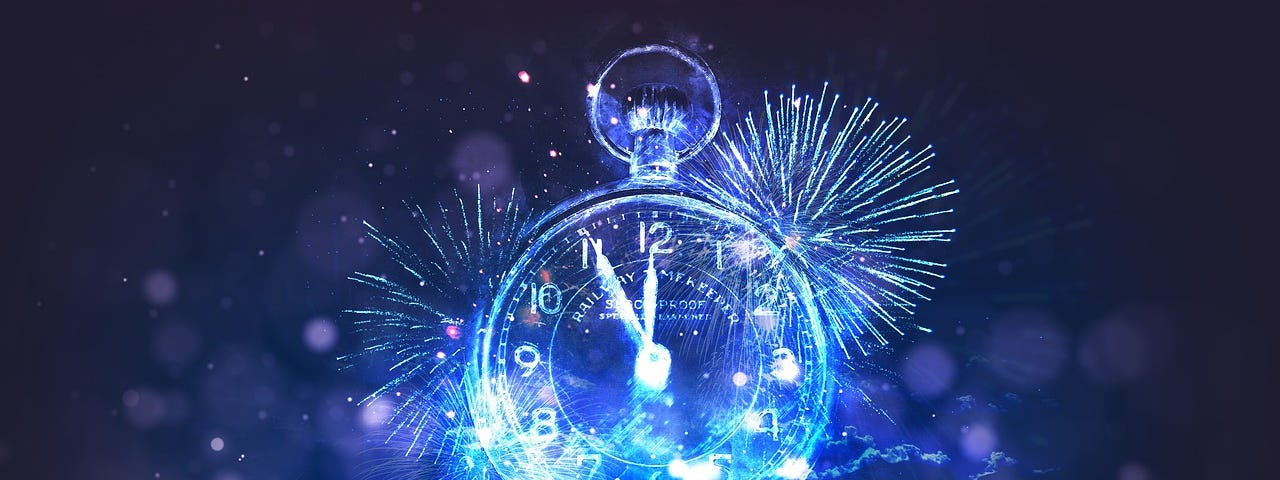 A blue stopwatch, behind are the flash bangs of blue fireworks, and the time om the clock is five minutes to midnight.