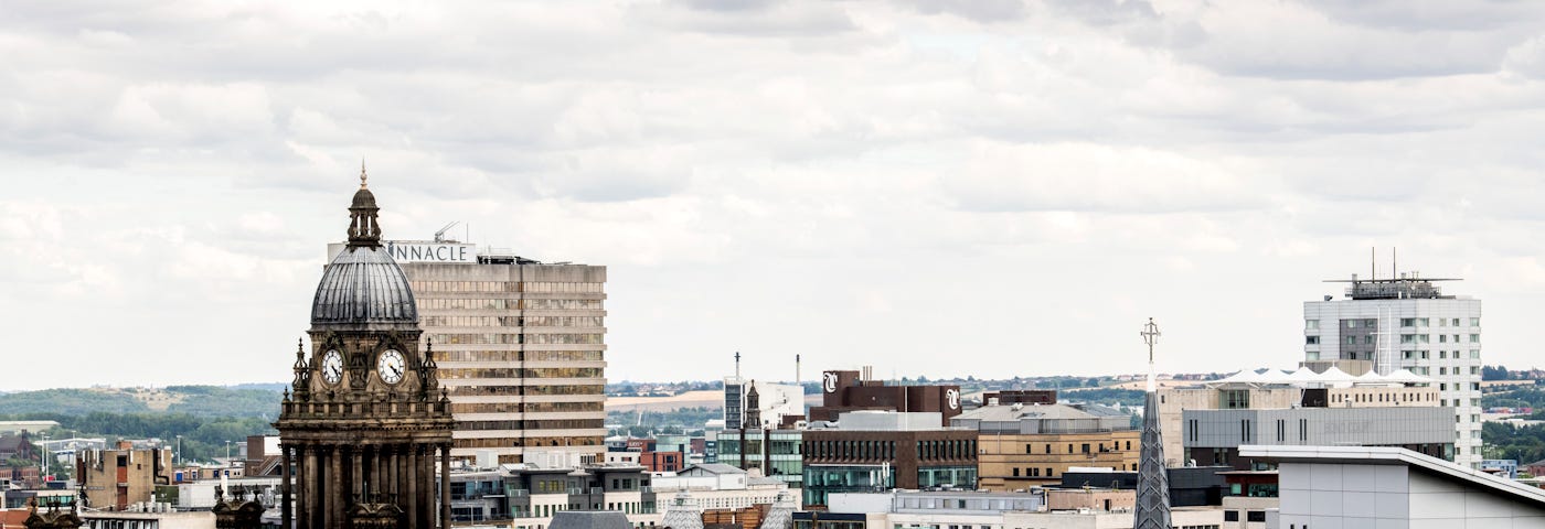 View of Leeds city centre over roof tops on a cloudy day.