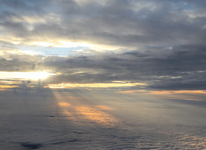 Sun setting above a thick cloud cover