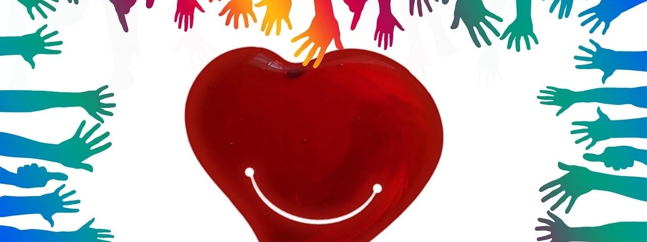 Graphic of a rainbow of hands surrounding a smiling red heart on a white background