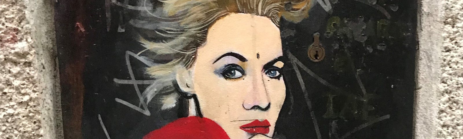 Street art of a woman in a red cloak.