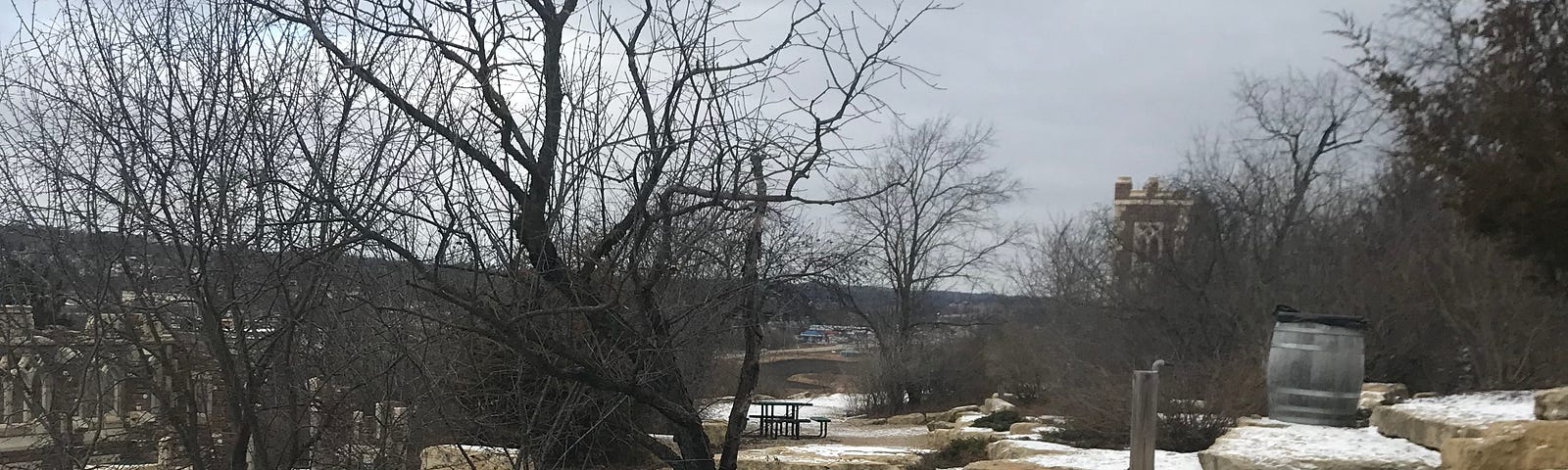 Photo taken by author in nature with large rocks, trees and snow.