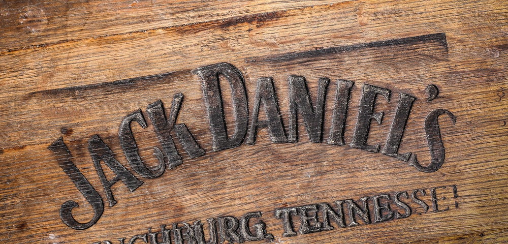 Jack Daniels whiskey logo burned at the bottom of old wooden barrel