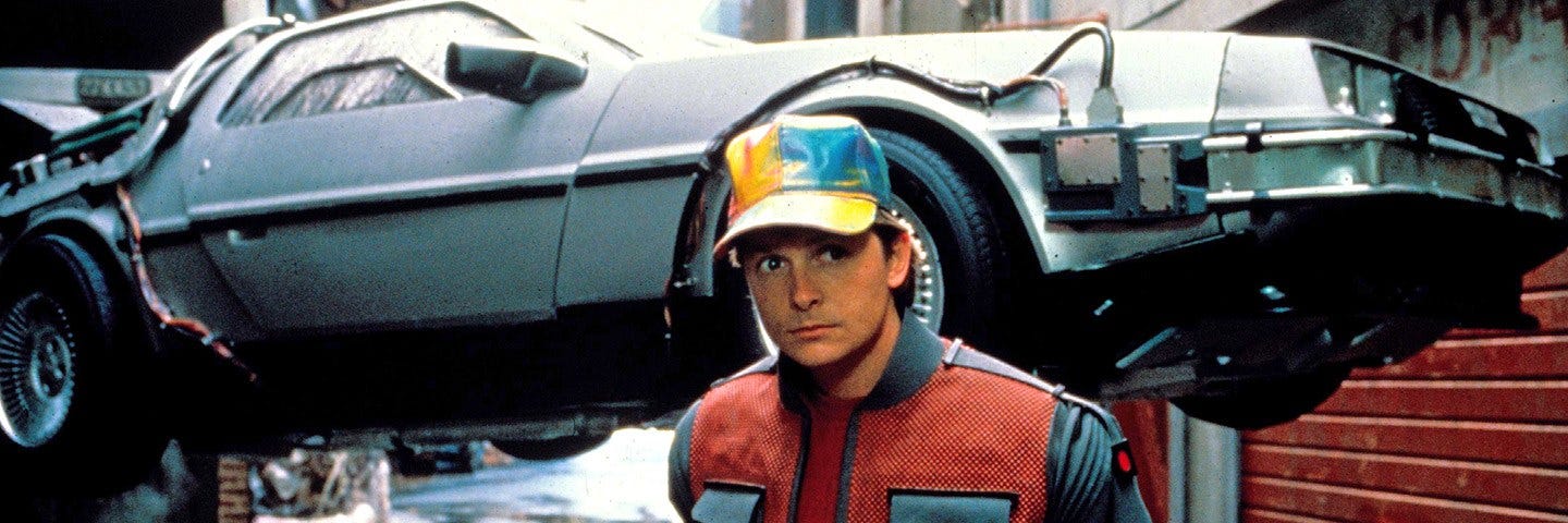 Marty McFly (Michael J. Fox) in front of the flying DeLorean time machine from Back To the Future