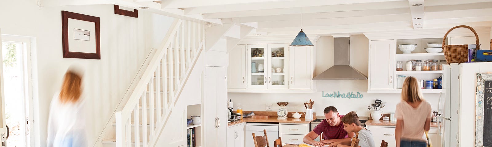 A dysfunctional family moves through their kitchen in a busy blur.