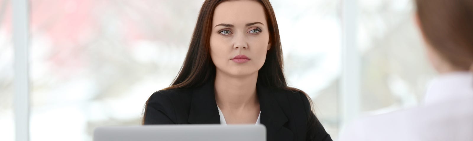 Image of a Senior Women Executive giving feedback to a Team Member