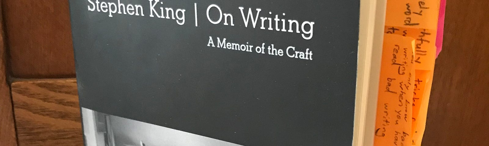 Photo of a used copy of Stephen King’s memoir book with orange and pink Post-It notes dividing key sections.