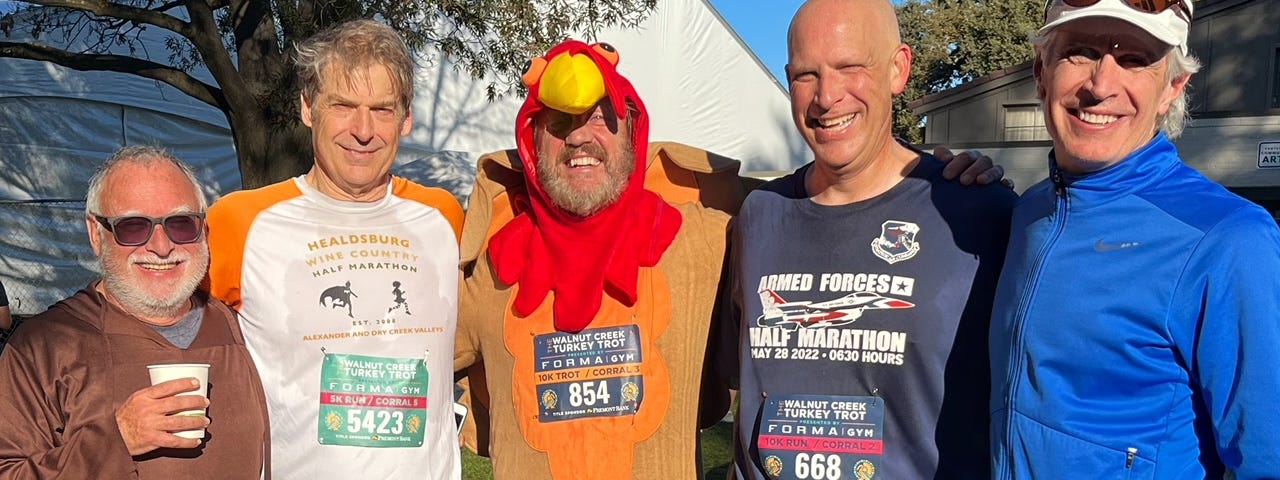 Five runners standing together after finishing a Thanksgiving Turkey Trot (one in turkey costume!)