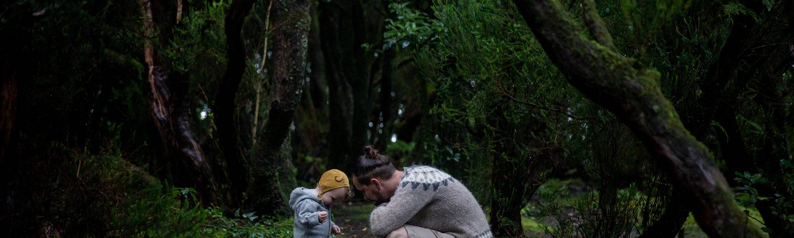 A father and son on the woods.