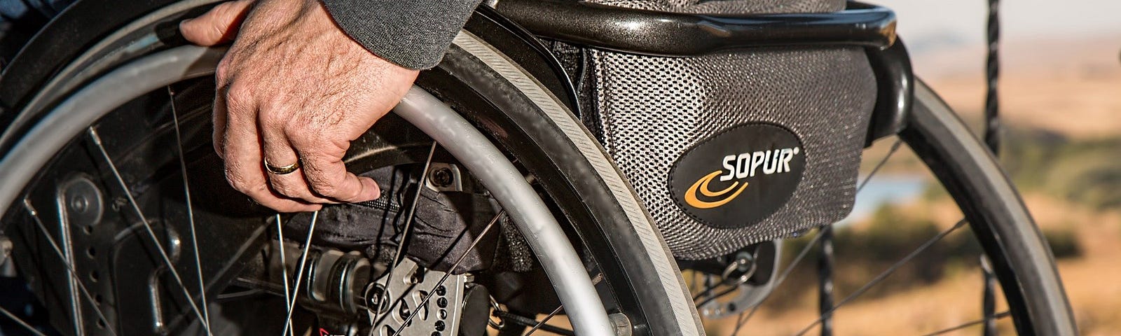 A close up picture of the side of a wheelchair