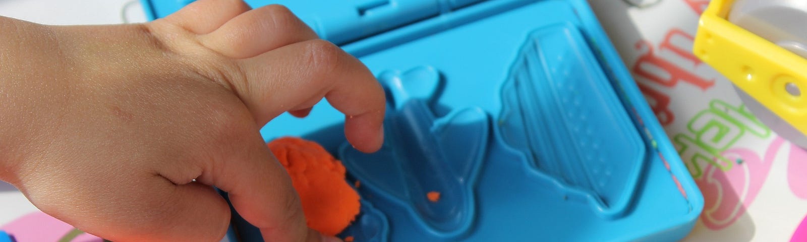 A child playing with putty.