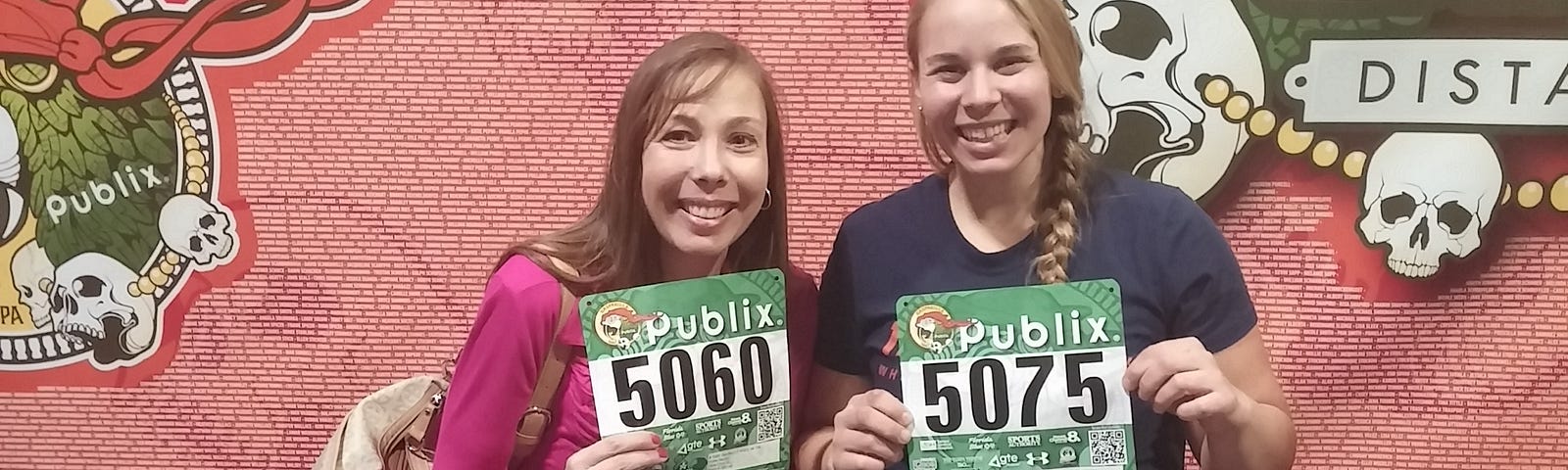 A mother and daughter holding race bib numbers for the Gasparilla 15K