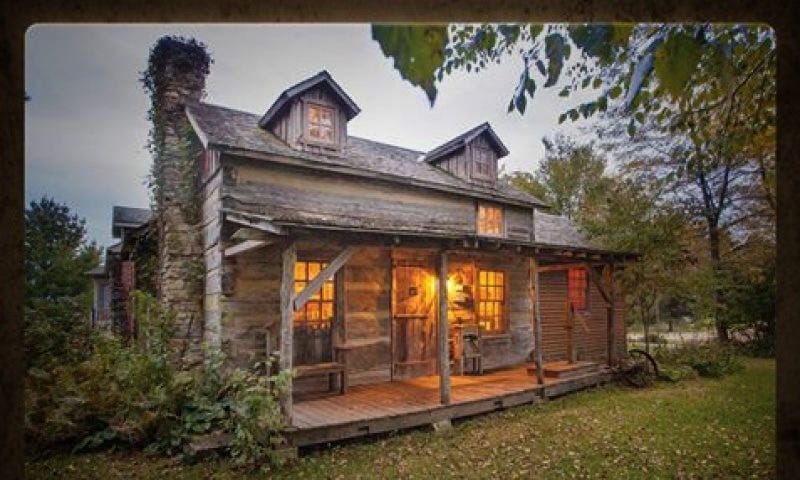 a wood cabin, illuminated by the reddish wood glowing from the moonlight. It is well kept but feels dark and deceptive.