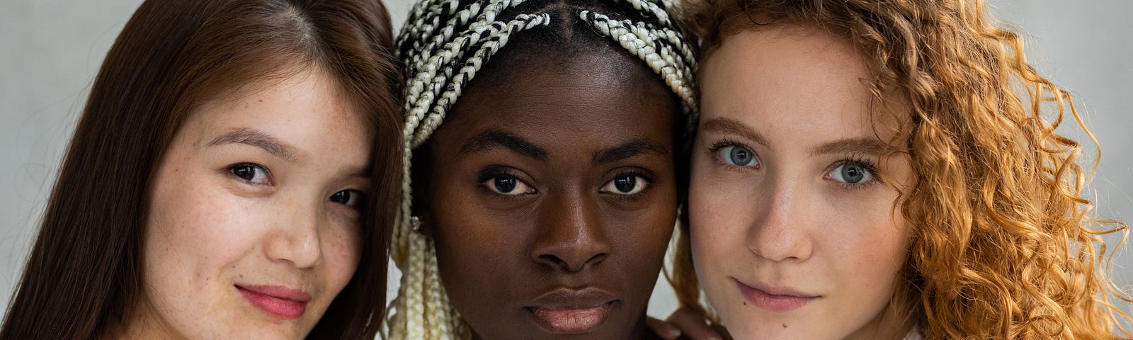 Diverse women standing close and looking at camera