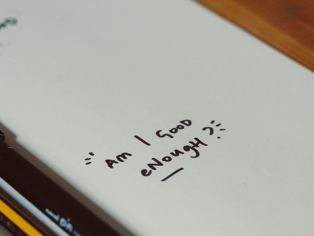 A white page says “Am I good enough?” written in black marker