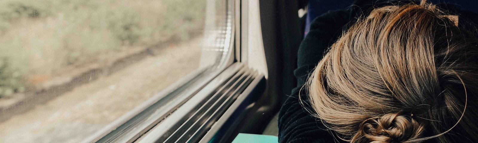 A tired woman on a train.