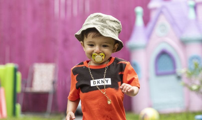 Toddler Jareem Akram with his solid gold dummy and DKNY t-shirt! Credits: Mirror.co.uk