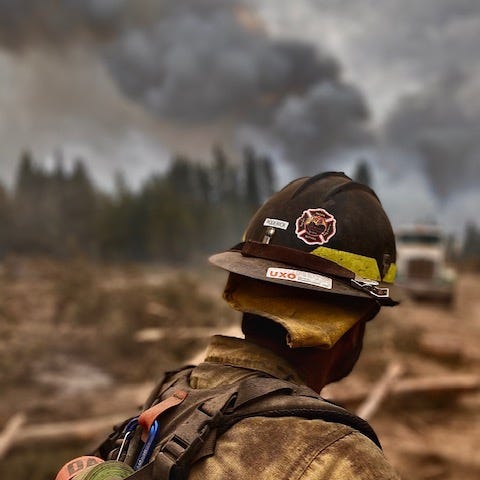 a man wearing fire fighting equipment