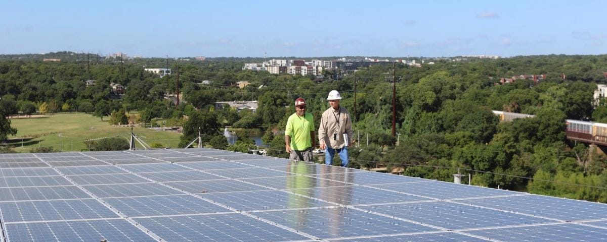 Solar installers inspecting solar panels
