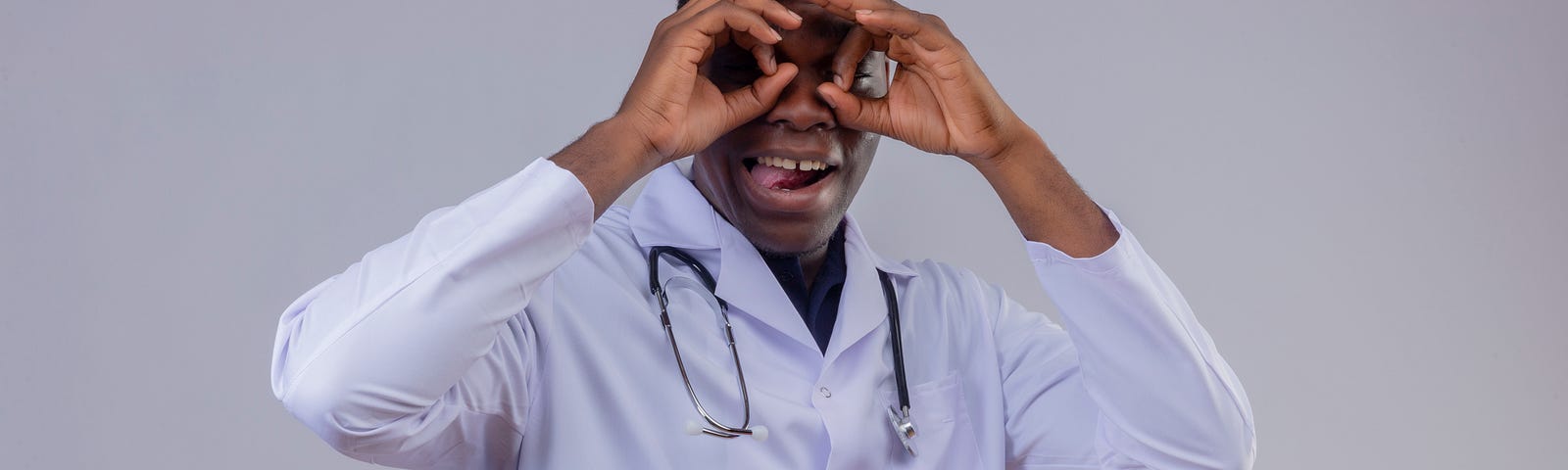 Young african american doctor wearing white coat with
