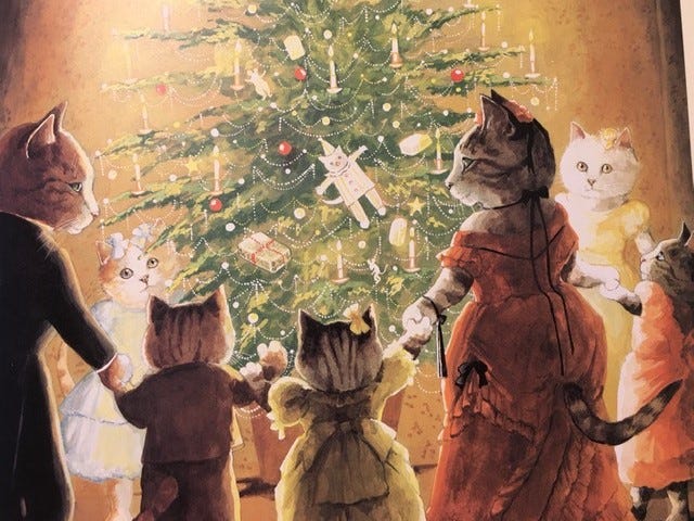 An image of cats dressed in clothes standing in front of a Christmas tree.