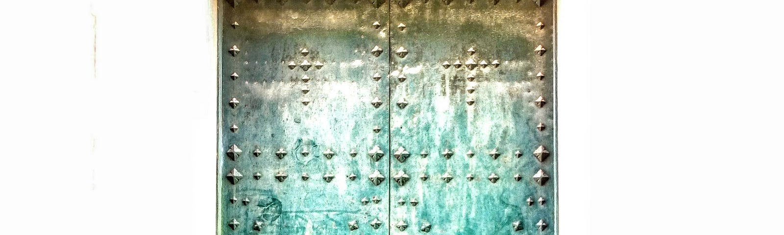 Metal door of a church. Some 250 years old. Open the door to understanding.