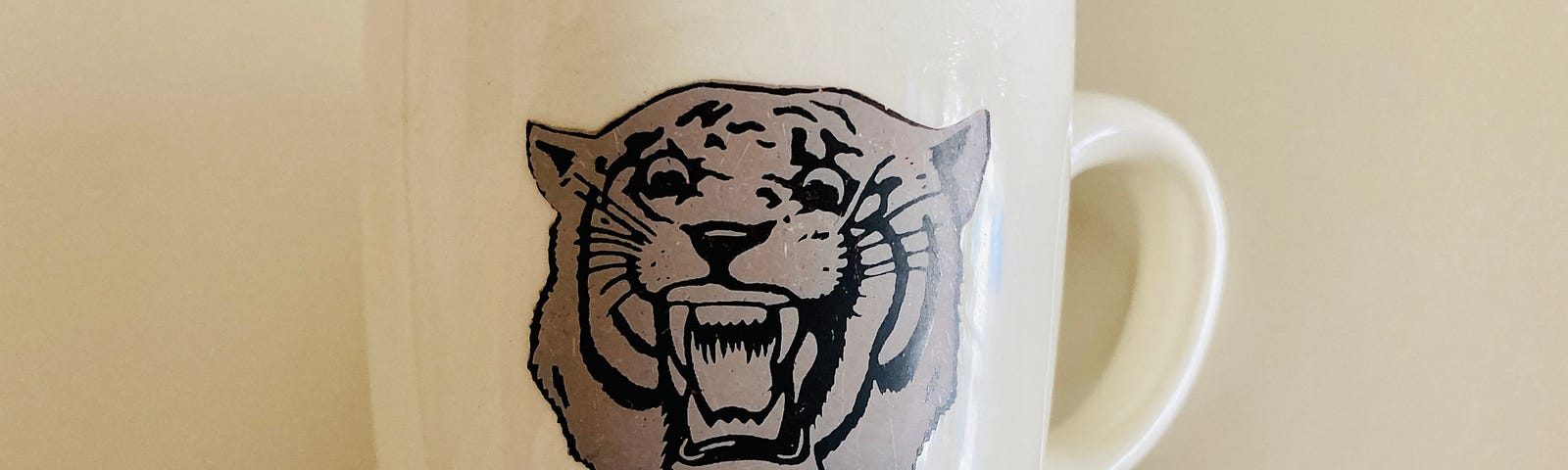 Photo of old coffee cup with faded Detroit Tigers’ logo. (Photo property of author).