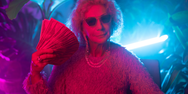 Photo of an older woman with sunglasses and holding money in her hand — 5 Ways to Become a Millionaire Blogger