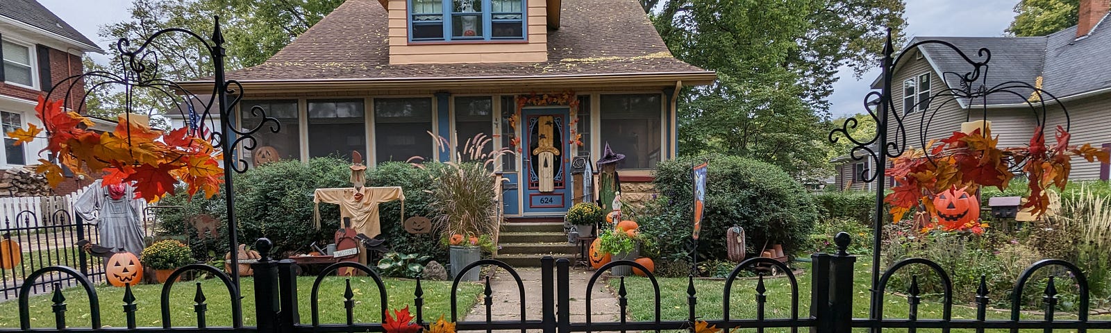 This photo features a house with Halloween and fall decorations.