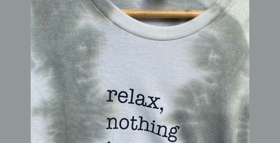 Picture of a t-shirt with a saying on it that says “Relax, nothing is under control.”