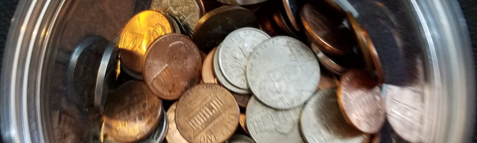 A jar of coins on a black background