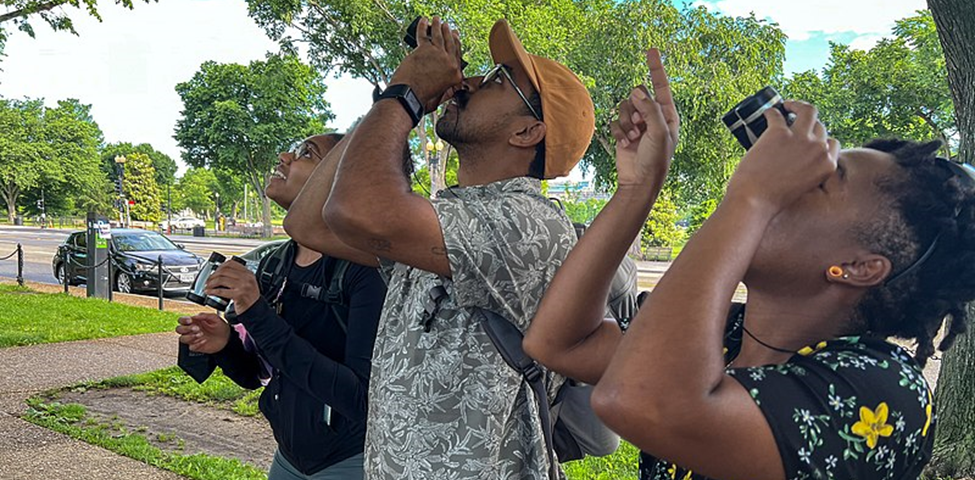 Description English: A group of birders look up through binoculars at a bird. Author Dara Miles Wilson. This file is licensed under the Creative Commons Attribution-Share Alike 4.0 International license. File: NMAAHC Bird Walk.jpg — Wikimedia Commons