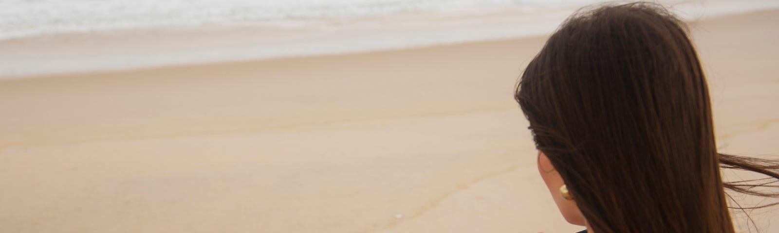 Woman writing on a beach