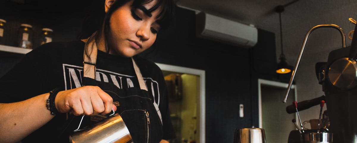 A young woman barista.