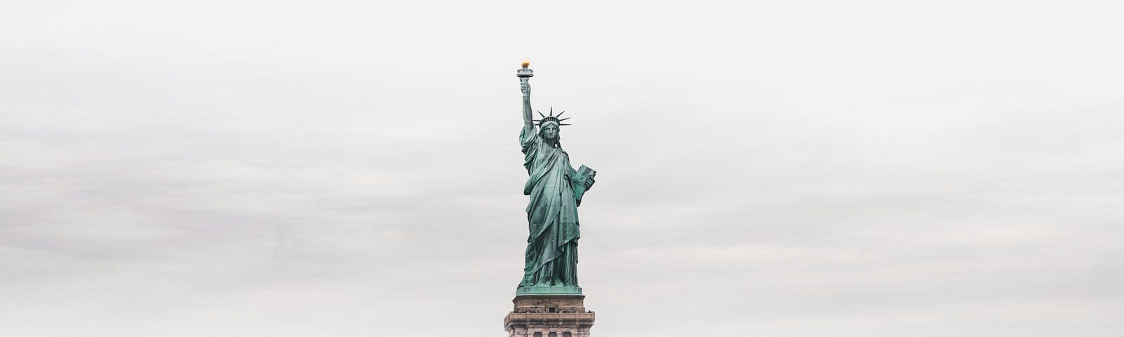 statue of liberty obscured by fog, but coming back into focus (Republicans for Harris)