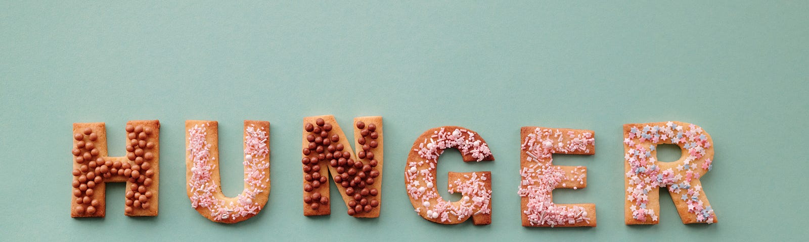 Cookies that are cut into letters and arranged to spell the word “HUNGER”