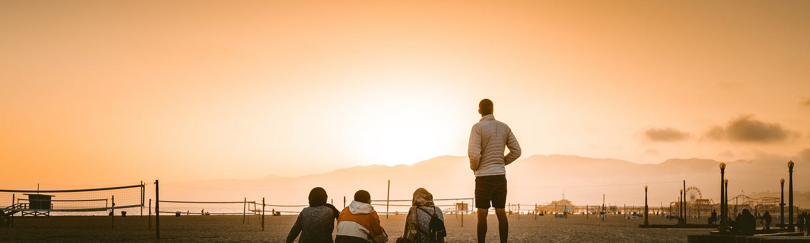 Four friends watching the sunset together.