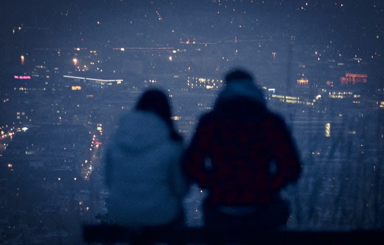 two people are overlooking city