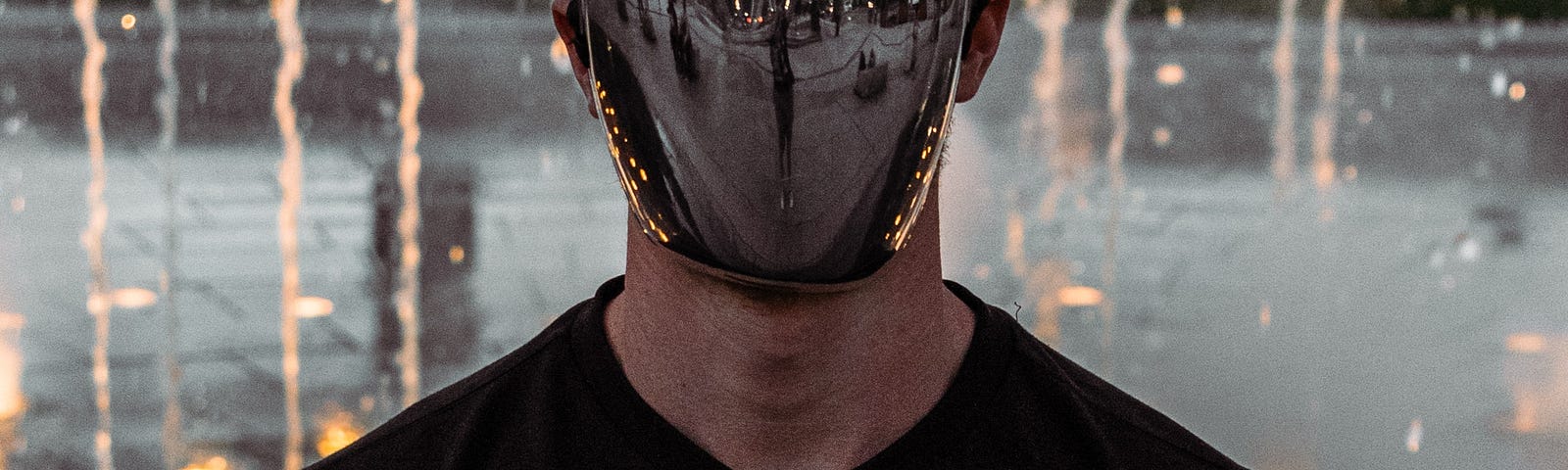 Man wearing mask made of reflective material.