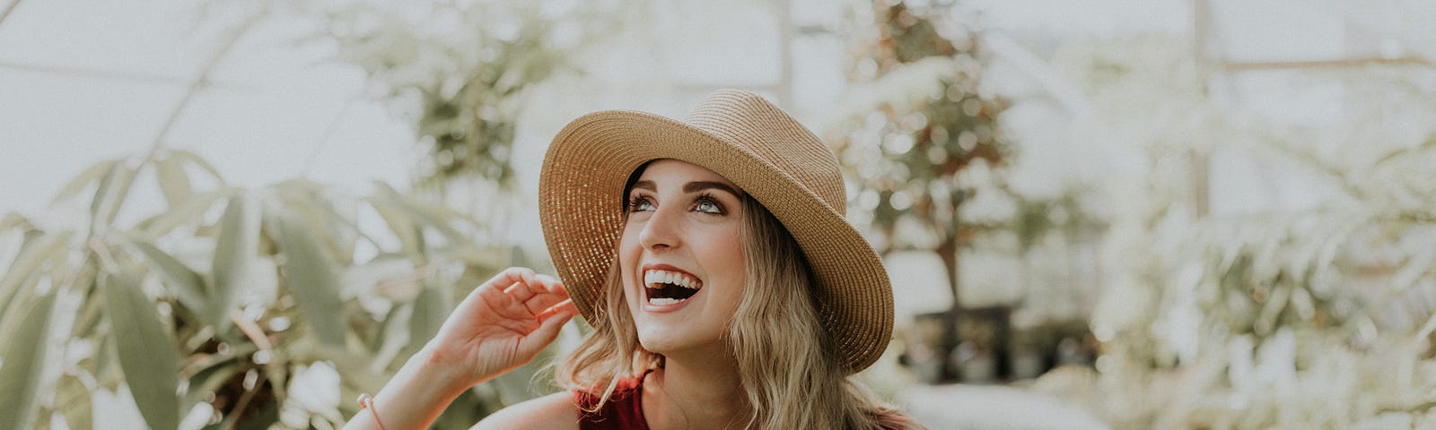 Woman with a hat displaying happiness and showing her soul is happy