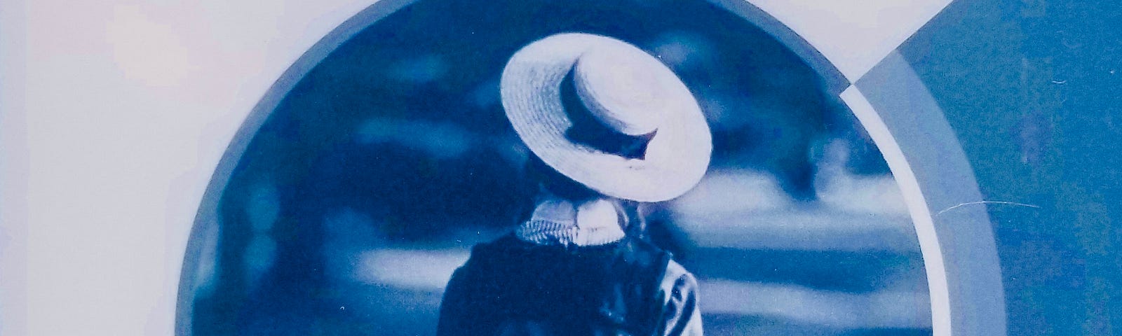 cover of the novel Anne of Green Gables picturing a girl facing backwards wearing a hat and early 20th Century dress.