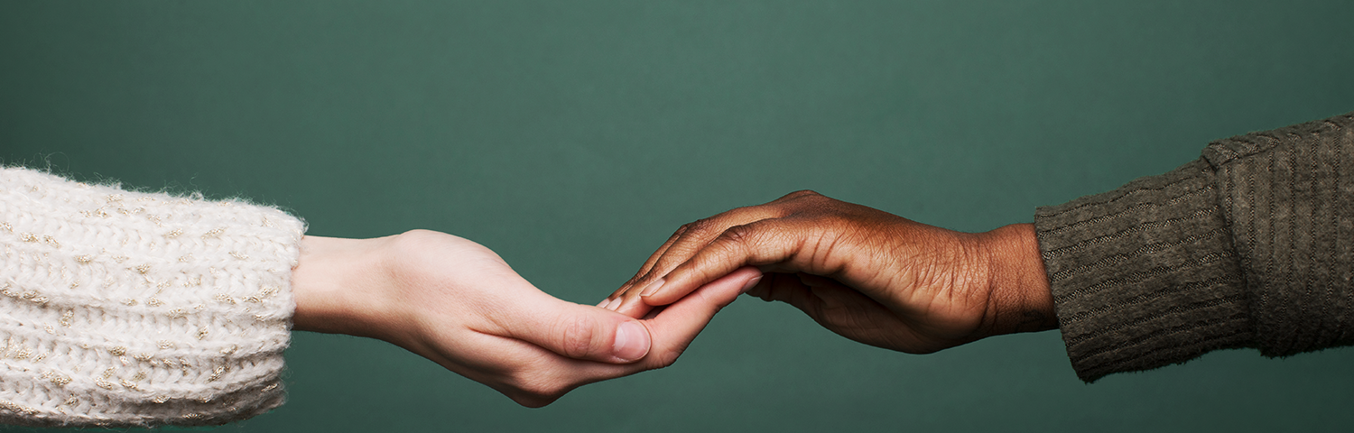 2 people touching hands in a show of community support