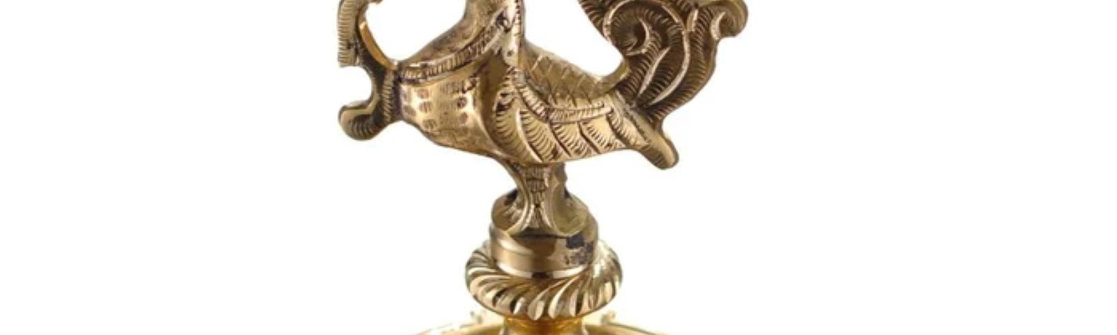 A shining brass oil lamp stand with a peacock head, Indian craft design