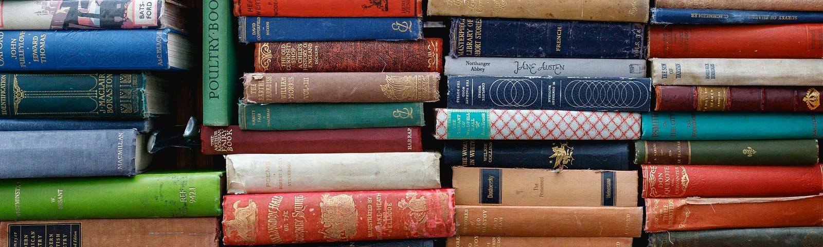 Several stacks of colorful books with their spines towards the camera.