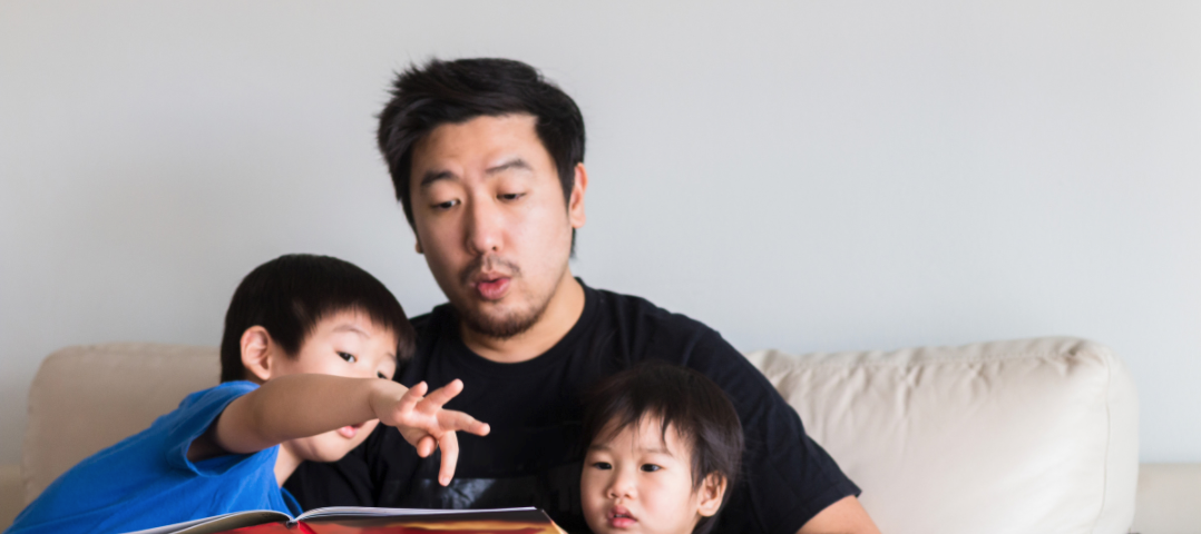 Father reading aloud with kids.