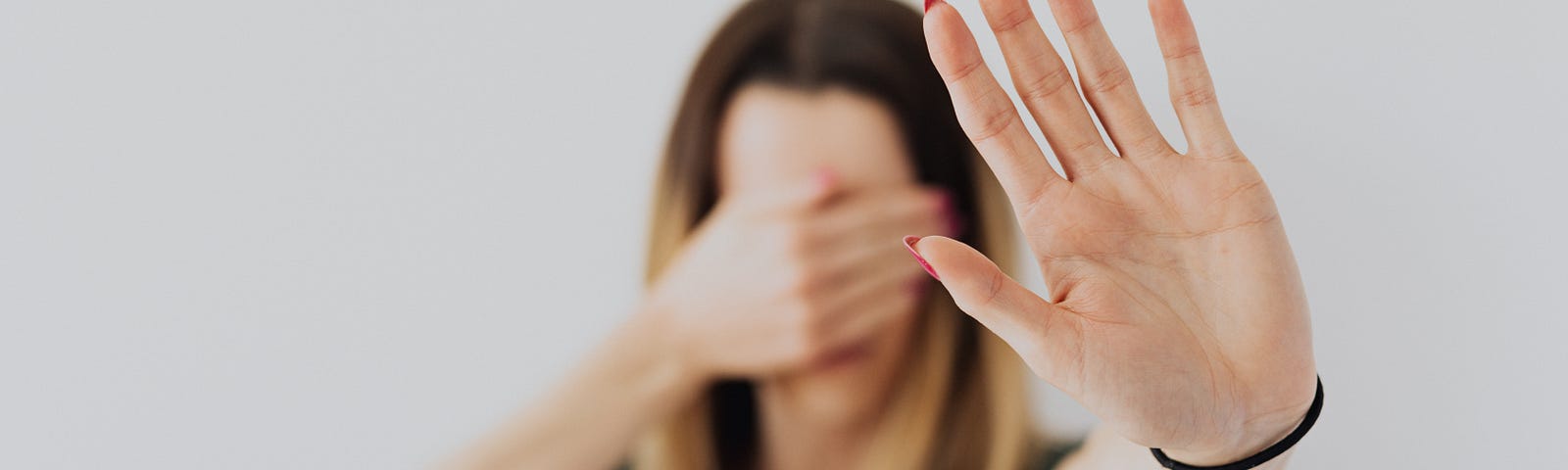 Woman holding up a hand for stop