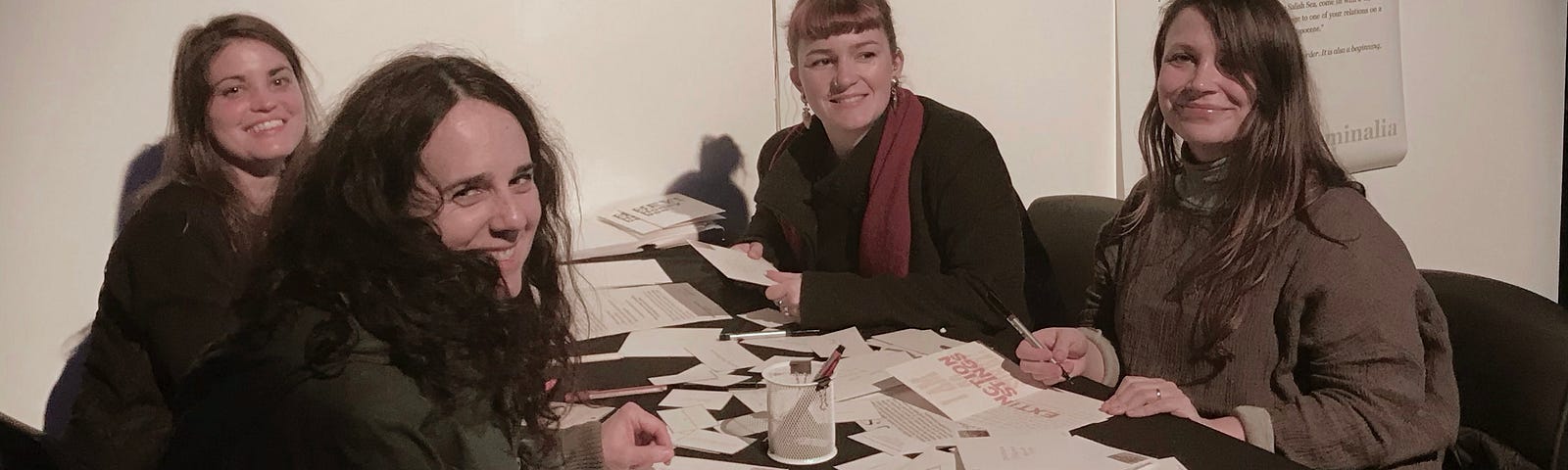 A group of gallery visitors pull writing prompts and compose messages on “Hey, Honey Bee!” greeting cards in Vancouver, BC.