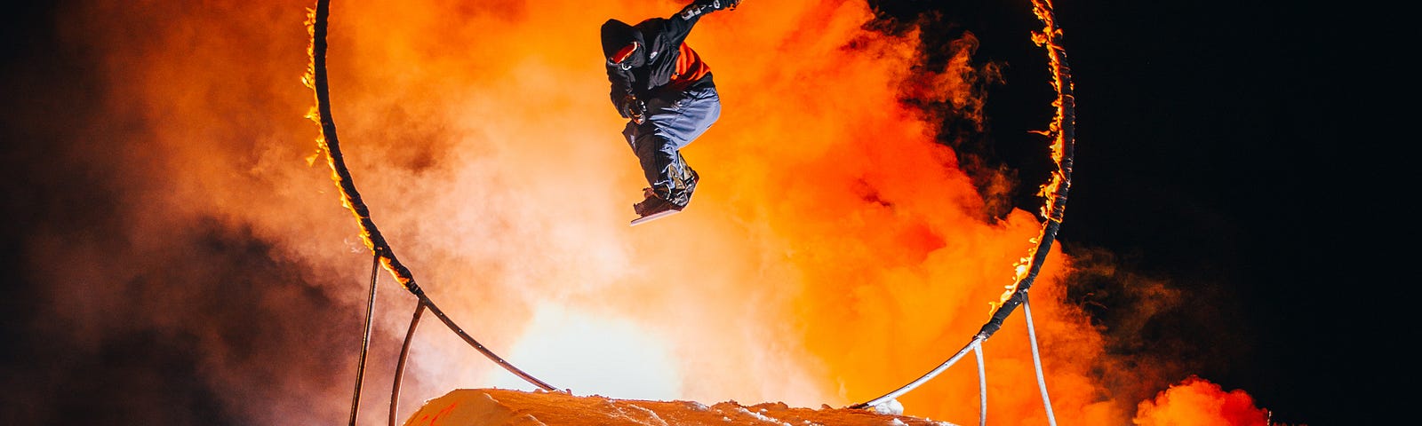 A Daredevil makes a scare jump through a fire rig.