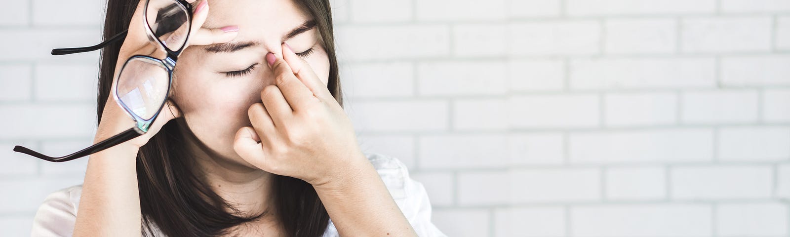 A woman showing discomfort from digital eye strain